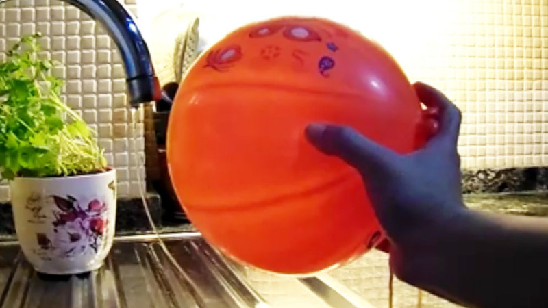 An experiment on static electricity, see how the water bends to this balloon.